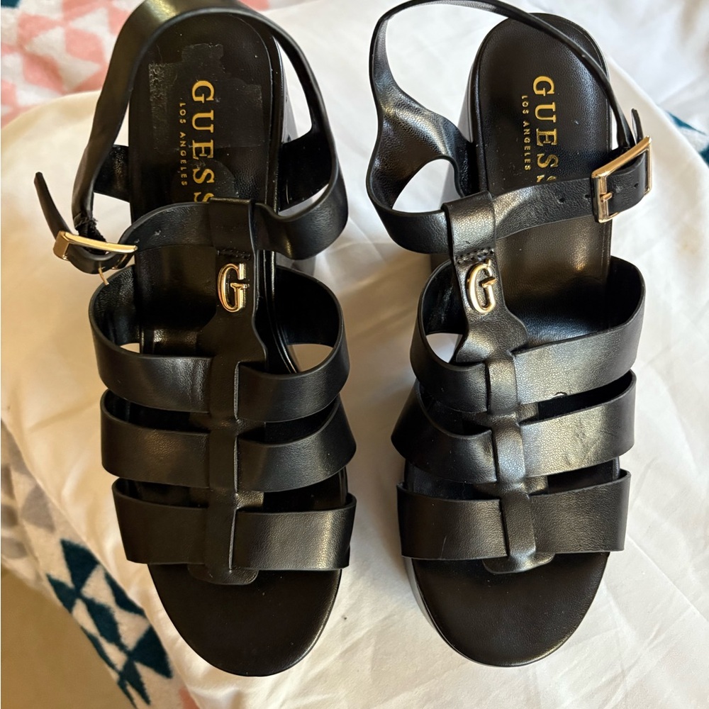 Guess Black Strappy Sandals with Gold Accents
new with out tag. Size 8.5.